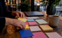 Hands sorting SEO strategy cards on desk