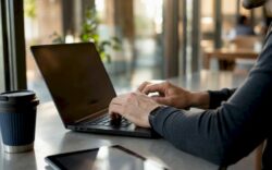 Developer typing mobile-first CSS at desk