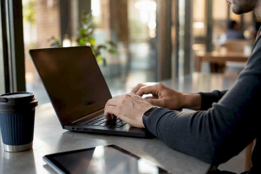 Developer typing mobile-first CSS at desk