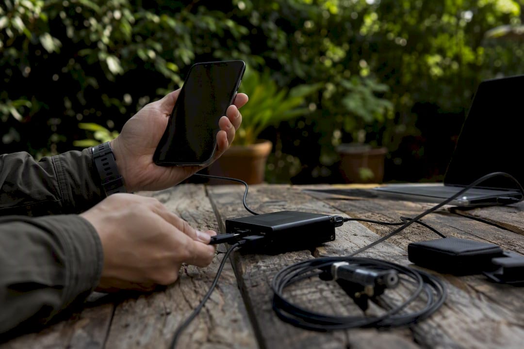 Hands connecting smartphone for performance tuning