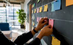 Hands moving Kanban cards on board