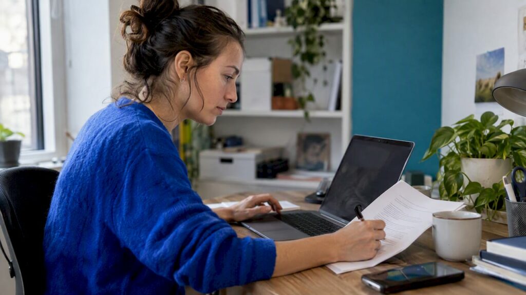 Editor revising web content at laptop
