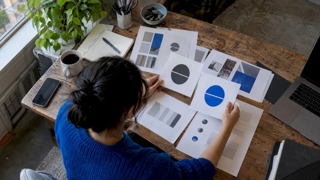 Designer comparing updated brand identity samples